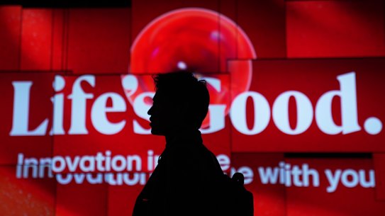 A person walks past screens at the LG Electronics booth during the CES tech show Tuesday, Jan. 6, 2026, in Las Vegas. (AP Photo/Abbie Parr)