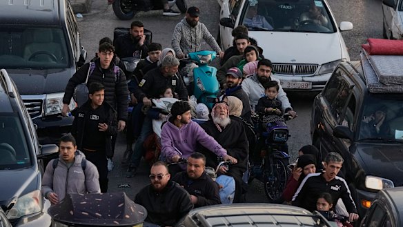 People fleeing Israeli airstrikes in Dahiyeh on Thursday.