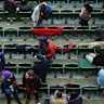 MCG Members reserve their seats during an AFL at the MCG.