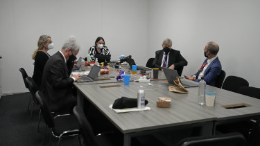 Delegates convene in a room as discussions continue at the COP26 Summit in Glasgow, Scotland, on Friday.