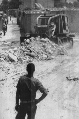 An Israeli army bulldozer clears the rubble of a house it knocked down during the clearing of a zone between the border fence and the first homes in Rafah.