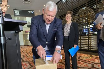 Report author Mark Trowell QC unveiling the document on Saturday.