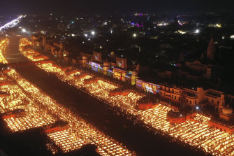 People light oil lamps on the banks of the river Saryu in Ayodhya, India.