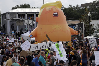 Protesters with the inflatable Baby Trump balloon at a June rally in Orlando, Florida. 