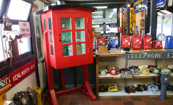 A rare half telephone box - known as the "bum freezer" because it offered shelter only to the user's upper body - and other vintage phones for sale.