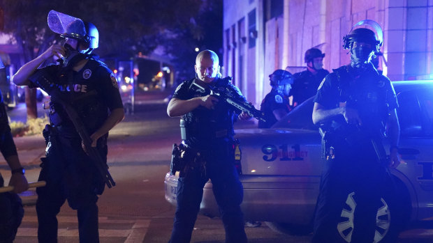 Police in Louisville stand guard after an officer was shot.