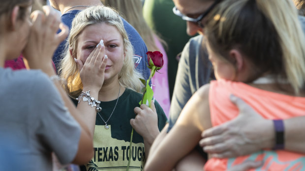 A woman wipes away tears during a prayer vigil following a shooting at Santa Fe High School in Santa Fe, Texa.