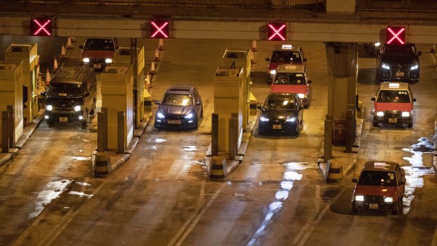 Vehicles move through the Cross-Harbour Tunnel, which has reopened, in Hong Kong.