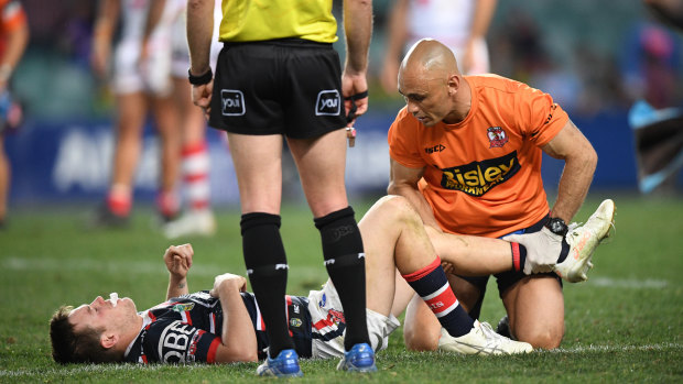 Man down: Luke Keary receives treatment. The prognosis was later revealed as more likely an MCL, not an ACL, injury.