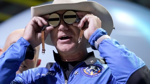 Jeff Bezos, founder of Amazon and space tourism company Blue Origin, puts goggles over his eyes that belonged to aviator Amelia Mary Earhart during a post launch news briefing from its spaceport near Van Horn, Texas.