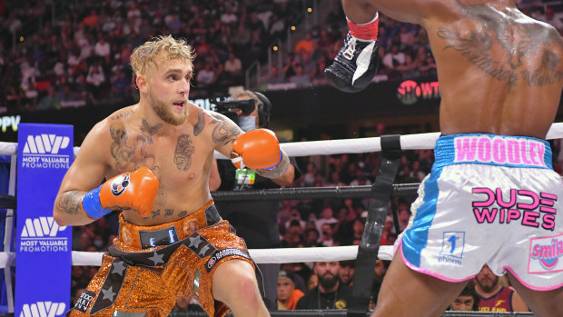 Jake Paul shapes up Tyron Woodley in their cruiserweight bout last year.
