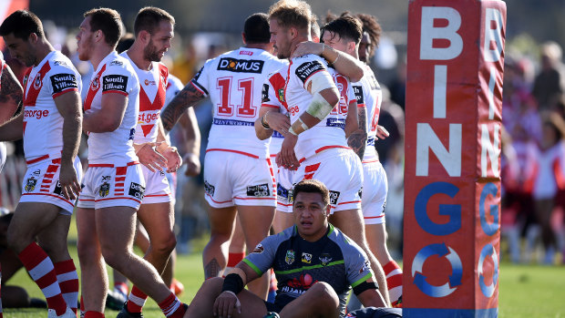 Josh Papalii looks forlorn as the Dragons celebrate a try.