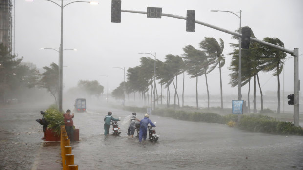 Motorists brave the rain and strong winds brought about by typhoon Mangkhut which made landfall in Baggao, Cagayan province, at 1.30am on Saturday..