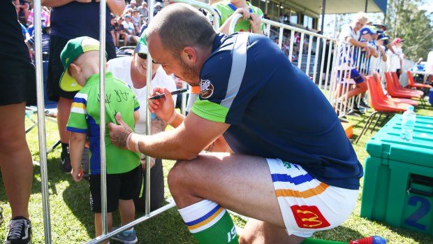 Raiders co-captain Josh Hodgson signs a young fans jersey - just one of the smiles the players put on kids faces during their trip to Bega.