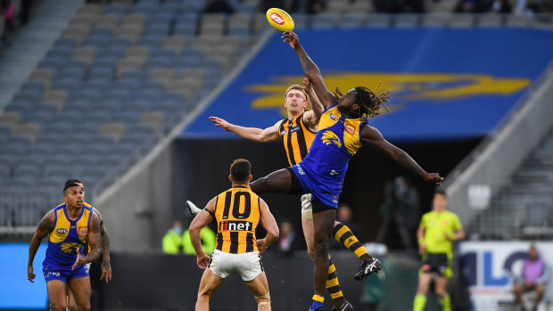 Tap out: Eagle Nic Naitanui goes up against Hawthorn's Ben McEvoy in a ruck contest.