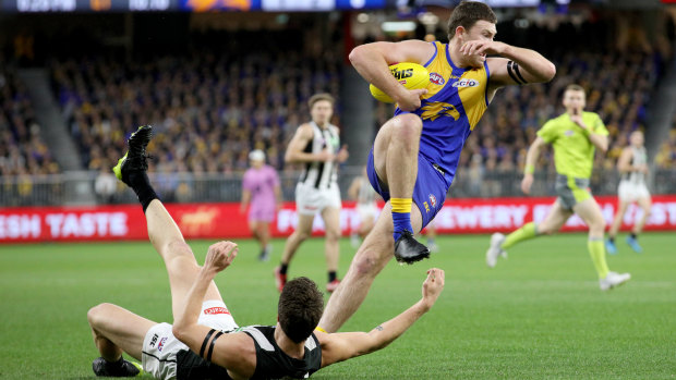 Grounded: West Coast's Jeremy McGovern gives Collingwood's Brody Mihocek the slip.