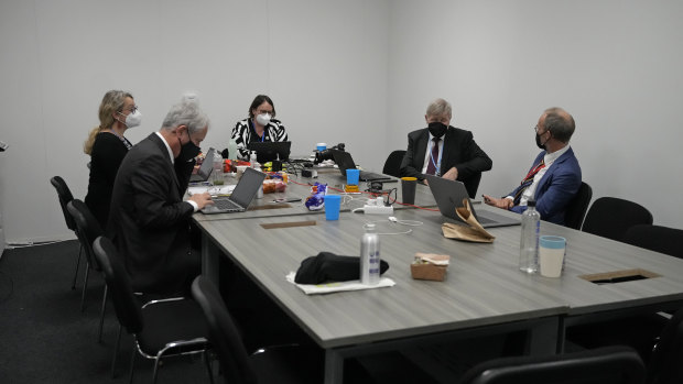 Delegates convene in a room as discussions continue at the COP26 Summit in Glasgow, Scotland, on Friday.