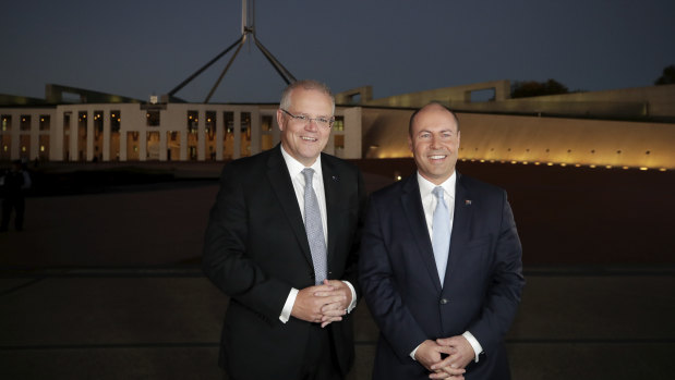 Prime Minister Scott Morrison and Treasurer Josh Frydenberg arrive for early morning interviews at Parliament House on Wednesday after delivering a budget that promised tax cuts in the years to come.