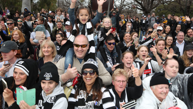 Fans line the streets during the AFL grand final parade. 