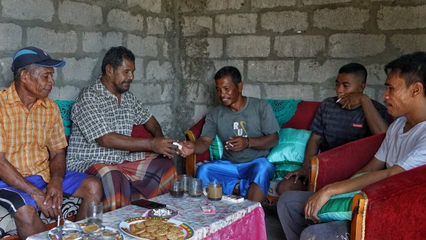 The fishermen gathered in the Papela home of Dahlan Karabi (second from left) to share their troubles with us.