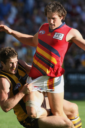 Hawthorn’s Campbell Brown tackles Adelaide’s Jason Porplyzia.