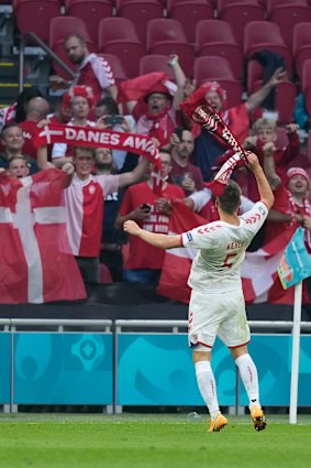 Denmark’s Joakim Maehle celebrates with fans.