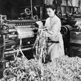 A factory worker produces foil, also known as ‘Window’, which was dropped by allied aircraft to jam enemy radar, circa 1943.