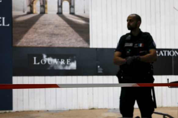 A police officer stands guard outside the Louvre in Paris as people are evacuated after it received a written threat on Saturday.