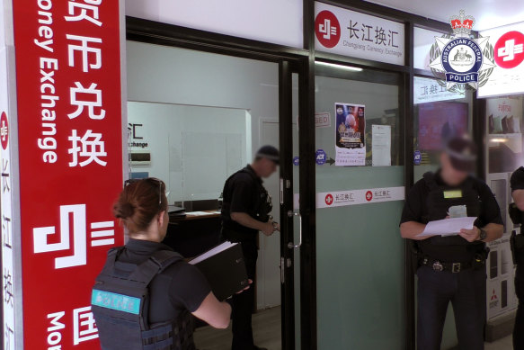 AFP officers issue a search warrant at a Changjiang shopfront in Sunnybank, Queensland.