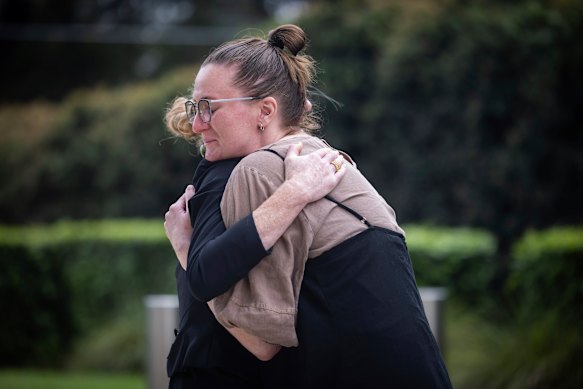 Outside the NSW Coroners Court at Lidcombe, Lisa Jokinen embraces her late father’s partner.