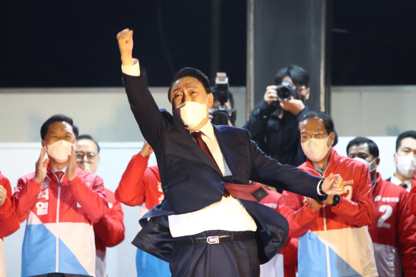 Newly elected president Yoon Suk-yeol celebrates with supporters in Seoul.