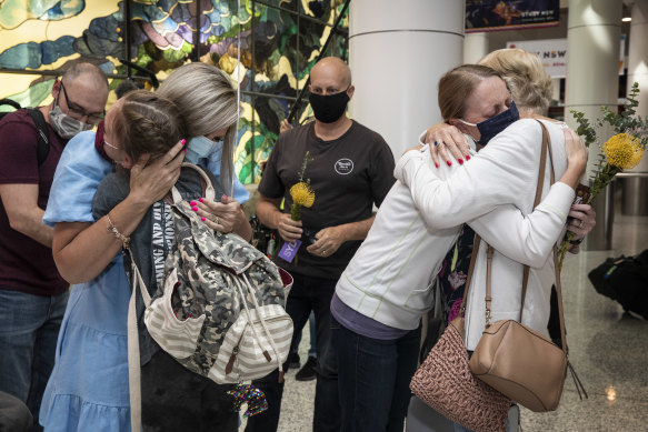 Families are reunited at Sydney airport after international border restrictions were eased in November.