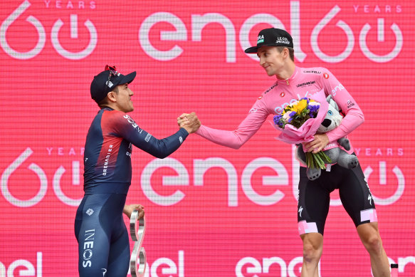 Jai Hindley, right, and Richard Carapaz, left, congratulate each other on the podium.