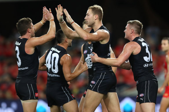 Harry McKay celebrates a goal with teammates.