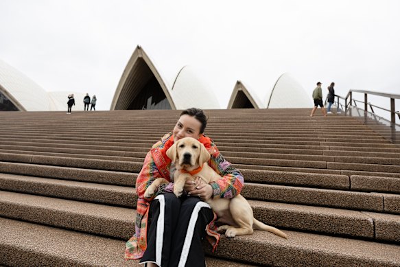 Molly Burke with four-month-old future guide dog Valentina. Her own guide dog, Elton, has stayed in Los Angeles.