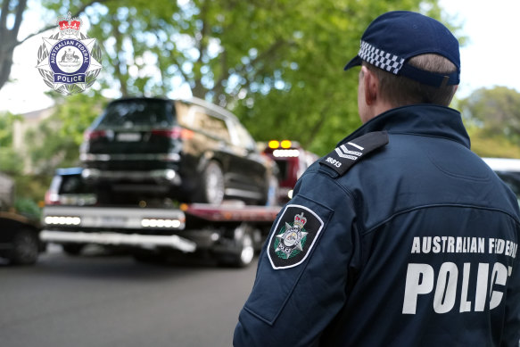 Federal police seize a luxury vehicle in Kew in connection with the investigation.
