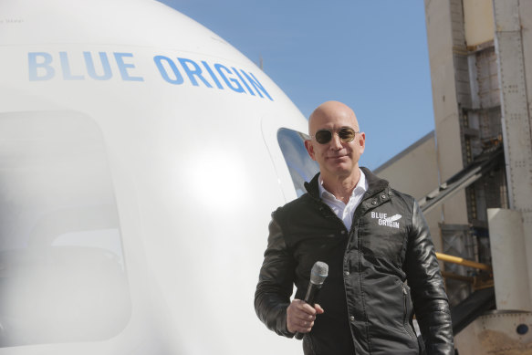 Jeff Bezos, chief executive of Amazon, with his Blue Origin New Shepard rocket. 