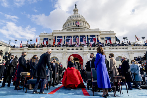 Lady Gaga arrives to perform the National Anthem as Joe Biden and Kamala Harris watch on, outside the US Capitol which was invaded by Trump supporters a fortnight ago.