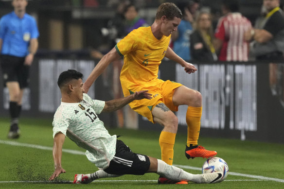 Kye Rowles tries to handle Hector Moreno.