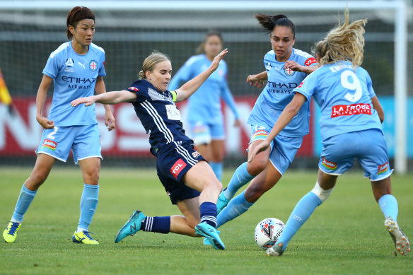 Victory's Natasha Dowie passes the ball under pressure from Melbourne City players during round five. 