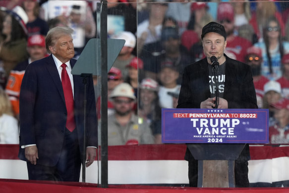 Donald Trump listens to Elon Musk at a campaign rally in Butler, Pennsylvania.