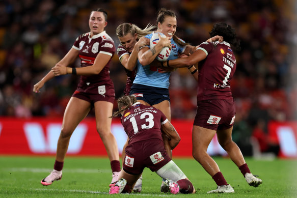 Sky Blues co-captain Isabelle Kelly takes a hit-up in game one at Suncorp Stadium.