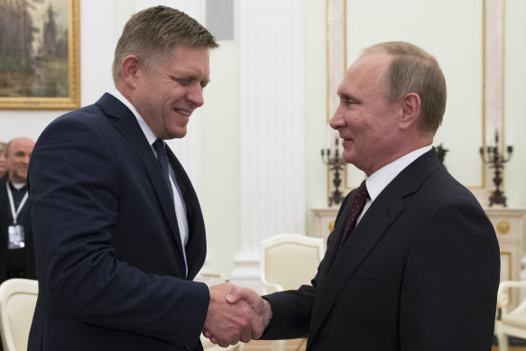 Slovak Prime Minister Robert Fico (left) shakes hands with Russian President Vladimir Putin in 2016.