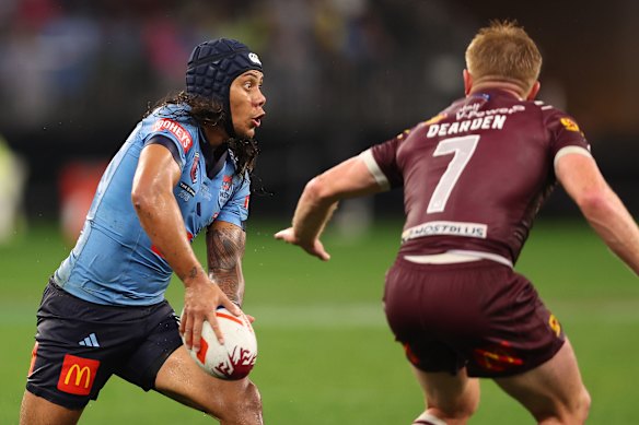 Jarome Luai gets a pass away as Queensland’s Tom Dearden closes in.