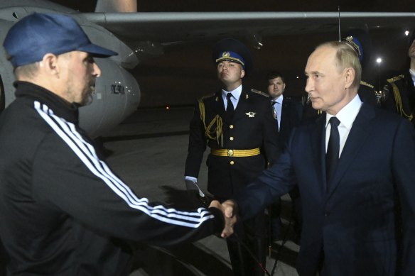 Russian President Vladimir Putin greets Vadim Krasikov upon arrival of freed Russian prisoners at Vnukovo government airport outside Moscow, Russia.