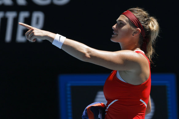 Aryna Sabalenka celebrates after defeating Wang Xinyu .