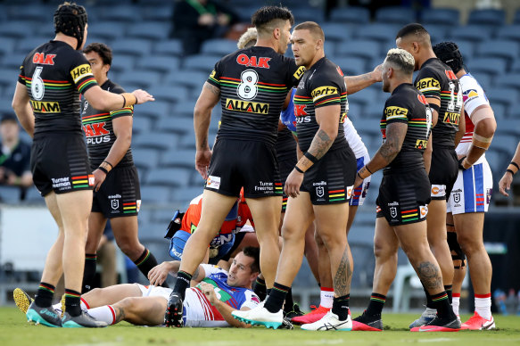 Mitchell Pearce lies injured on the field during the Knights' round-three clash against the Panthers at Campbelltown Stadium on Sunday.