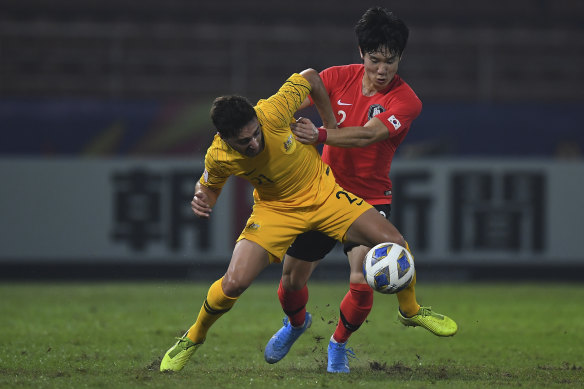 Jacob Italiano fights for the ball with Lee You-hyeon.