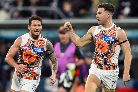 Toby Greene, right, celebrates a goal. 