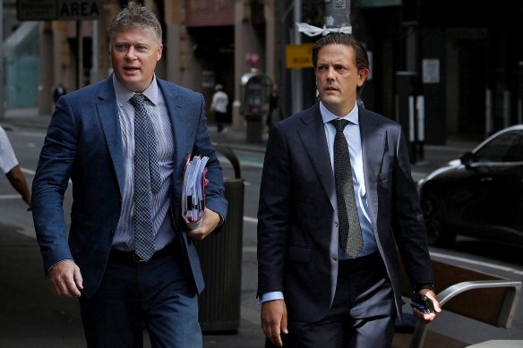 Former property executive Brett Henson (right) arrives at court with his lawyer Paul McGirr (left) for his hearing accused of drunkenly stealing a taxi.